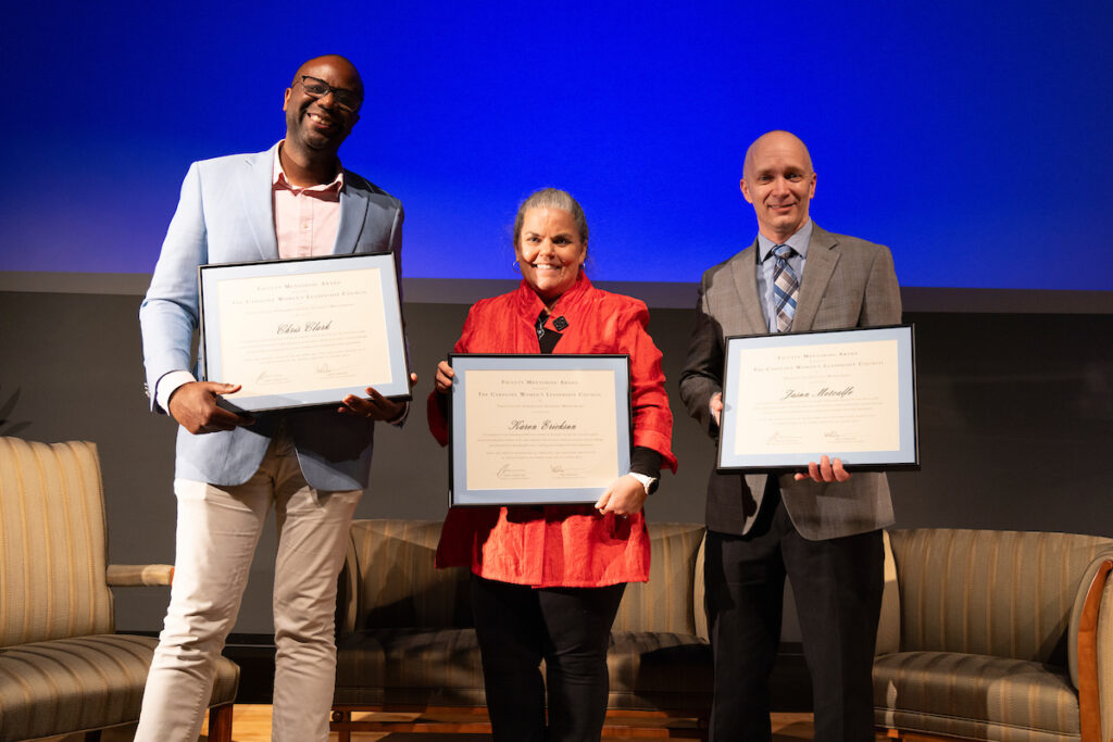 Faculty mentoring award recipients on stage holding awards
